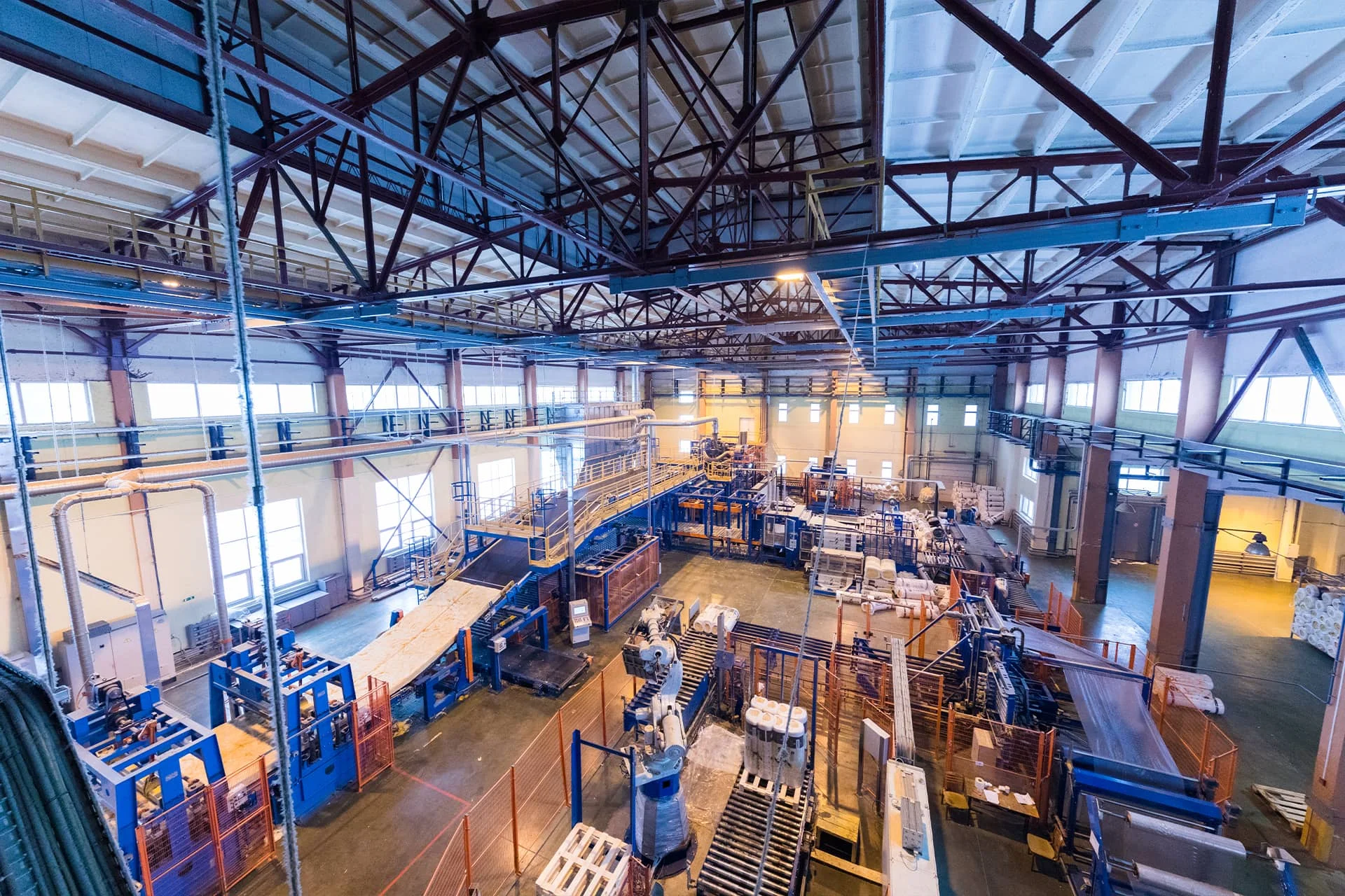 Large industrial processing hall with furnaces and overhead structures