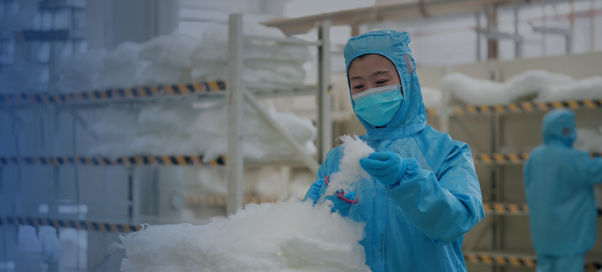 Operator handling white fiber in a production environment